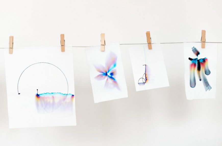 chromatography art on white papers hanging on a rope